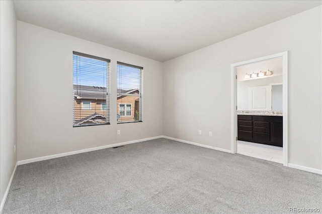 15492 W 65th Ave Unit C, Arvada, CO 80007 - unfurnished bedroom with light carpet and ensuite bathroom