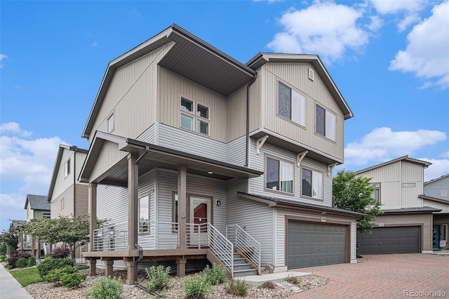 19096 E 55th Ave, Denver, CO 80249 - view of front of property with an attached garage, covered porch, and decorative driveway