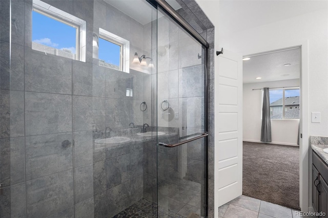 19096 E 55th Ave, Denver, CO 80249 - full bath with double vanity, plenty of natural light, a stall shower, recessed lighting, and tile patterned flooring
