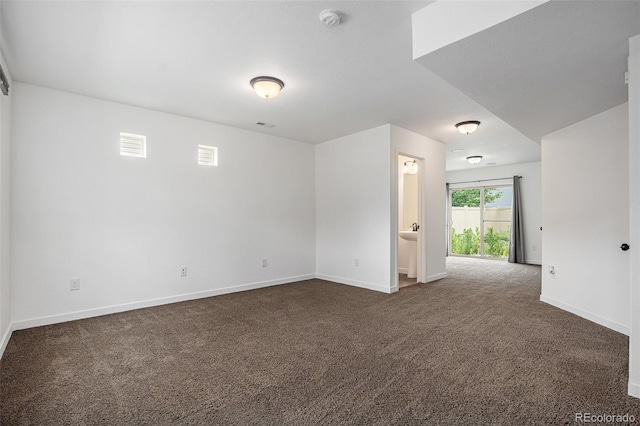 19096 E 55th Ave, Denver, CO 80249 - empty room featuring dark colored carpet, a smoke detector, and baseboards