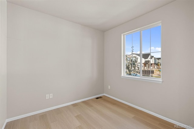 spare room with light hardwood / wood-style flooring