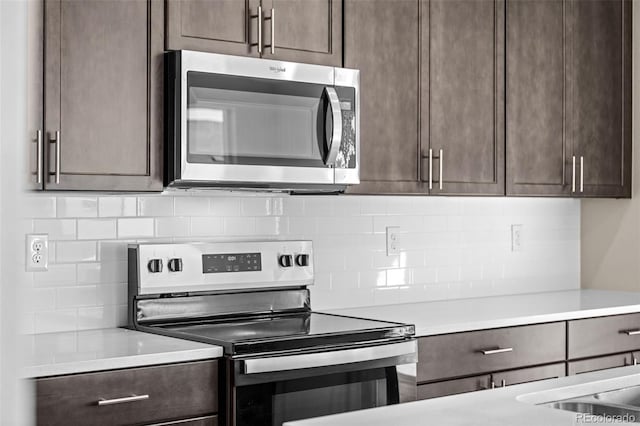 kitchen with decorative backsplash, dark brown cabinets, and stainless steel appliances