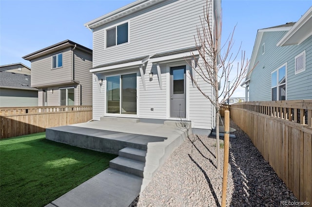 rear view of house featuring a yard