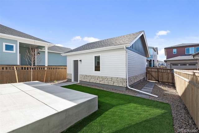 view of side of property featuring a yard and a patio