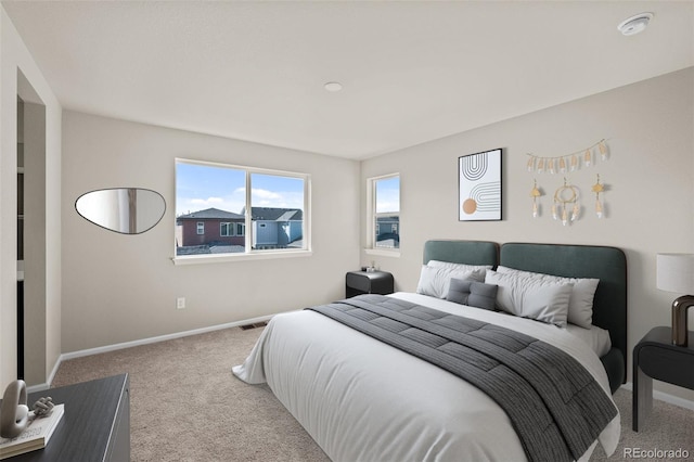 bedroom featuring light colored carpet