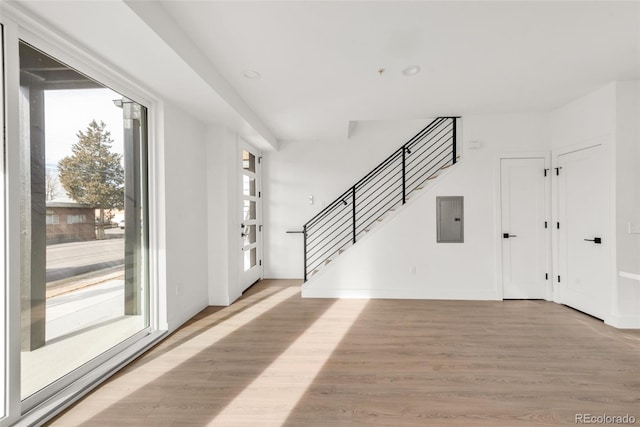 foyer entrance featuring electric panel and light hardwood / wood-style floors