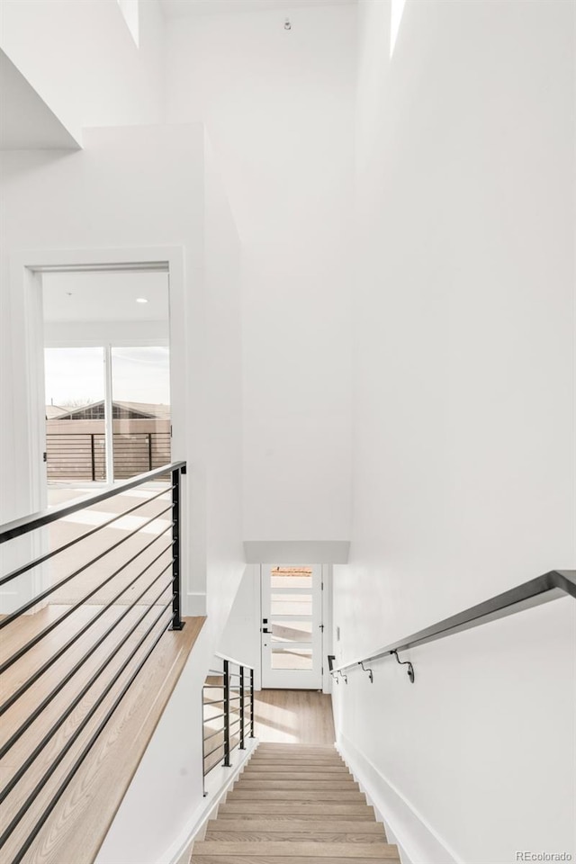 stairs with hardwood / wood-style floors