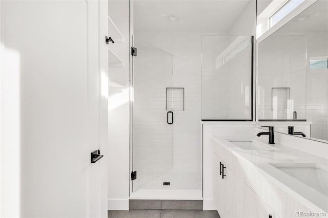 bathroom featuring tile patterned floors, vanity, and an enclosed shower