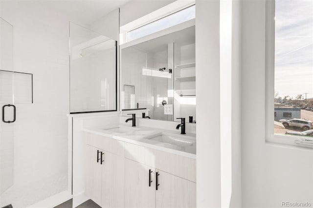 bathroom with vanity and a shower with door