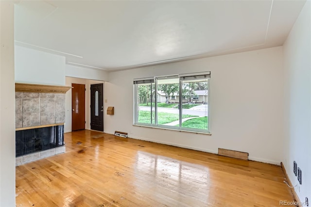 7995 Robin Ln, Denver, CO 80221 - unfurnished living room with a fireplace, wood finished floors, and baseboards