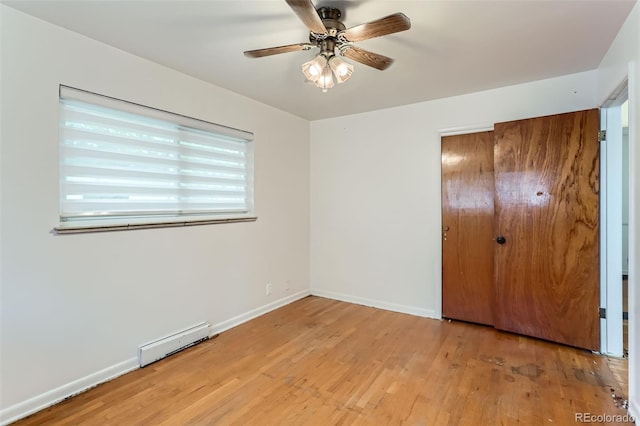 7995 Robin Ln, Denver, CO 80221 - unfurnished bedroom featuring a baseboard heating unit, hardwood / wood-style floors, baseboards, a closet, and ceiling fan