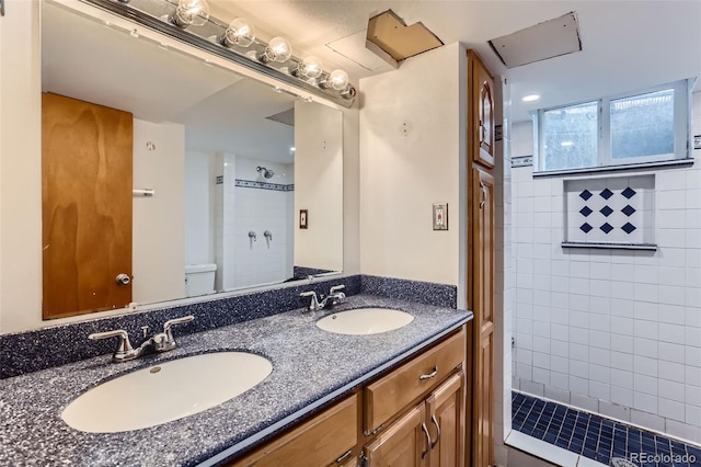 7995 Robin Ln, Denver, CO 80221 - full bathroom with tiled shower, double vanity, and toilet