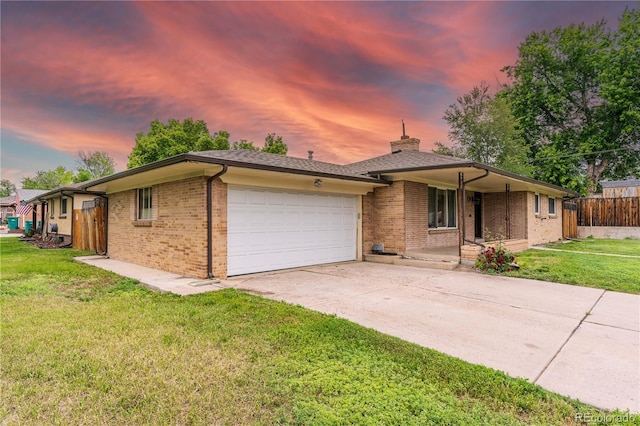 7995 Robin Ln, Denver, CO 80221 - ranch-style home featuring a garage, driveway, a chimney, brick siding, and covered porch