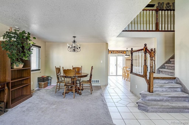 4863 Quail Ct, Frederick, CO 80504 - dining room with a textured ceiling, stairs, a chandelier, and light tile patterned flooring
