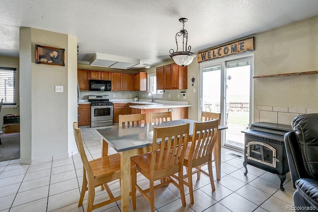 4863 Quail Ct, Frederick, CO 80504 - dining area with plenty of natural light, a textured ceiling, and light tile patterned flooring