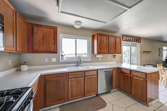 4863 Quail Ct, Frederick, CO 80504 - kitchen with dishwasher, a sink, a peninsula, a textured ceiling, and brown cabinetry