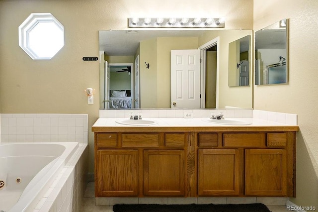 4863 Quail Ct, Frederick, CO 80504 - full bathroom featuring ensuite bath, double vanity, a jetted tub, and tile patterned flooring