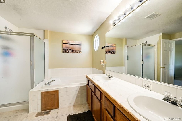 4863 Quail Ct, Frederick, CO 80504 - bathroom with a stall shower, a bath, double vanity, tile patterned floors, and a textured ceiling