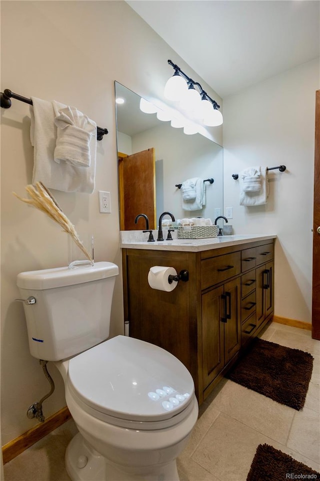 145 Arapahoe Rd Unit 102, Winter Park, CO 80482 - bathroom with toilet, baseboards, tile patterned floors, and vanity
