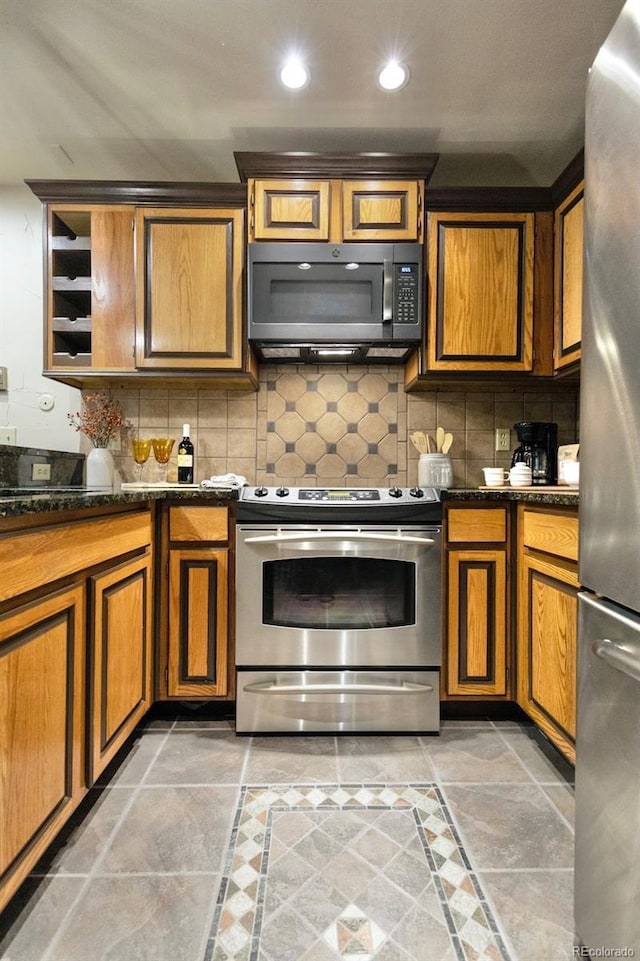 145 Arapahoe Rd Unit 102, Winter Park, CO 80482 - kitchen featuring appliances with stainless steel finishes, tasteful backsplash, brown cabinets, and recessed lighting