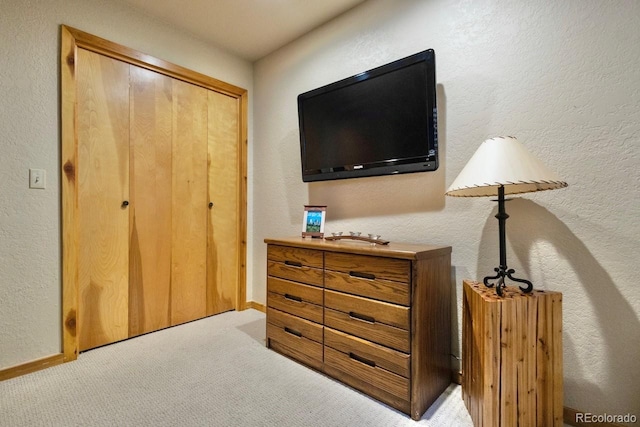 145 Arapahoe Rd Unit 102, Winter Park, CO 80482 - bedroom with light carpet, a closet, and a textured wall