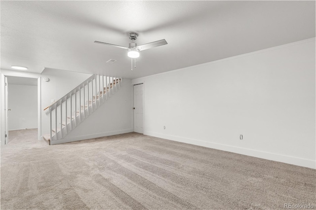 unfurnished living room with light carpet, ornamental molding, and ceiling fan