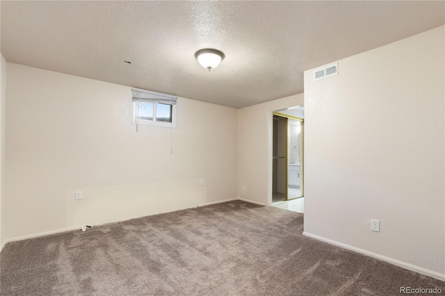 basement with a textured ceiling and carpet flooring