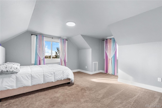 carpeted bedroom featuring lofted ceiling