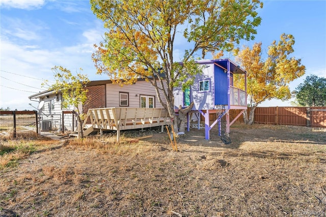 back of property with a wooden deck