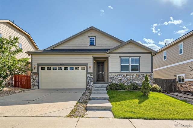 craftsman house with a front yard and a garage