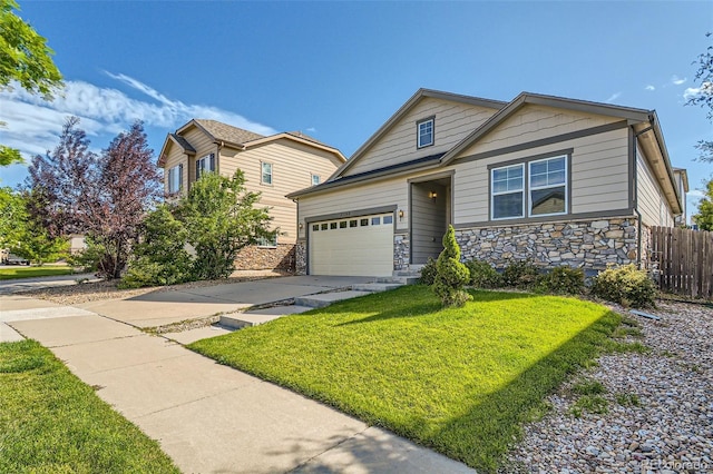 view of front of house with a front yard, stone siding, fence, and concrete driveway