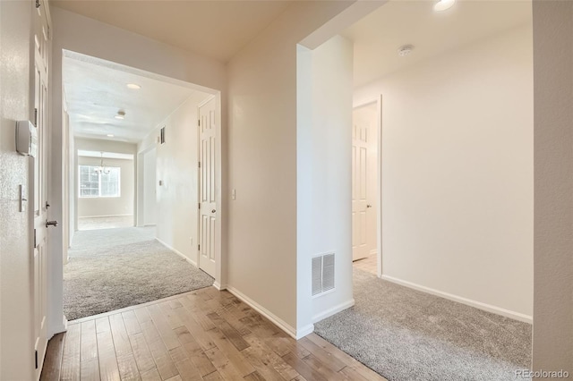 corridor with light wood-type flooring