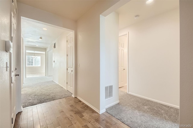 hall with baseboards, visible vents, wood finished floors, carpet flooring, and recessed lighting