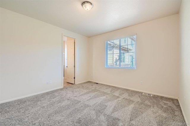 empty room with light carpet, baseboards, and visible vents