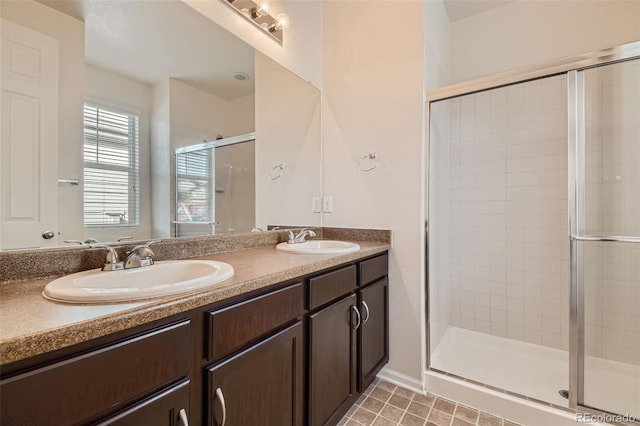 bathroom with vanity, a shower with shower door, and tile patterned floors