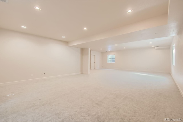 basement with baseboards, light colored carpet, and recessed lighting