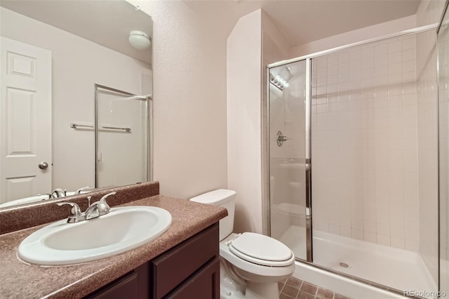 bathroom with an enclosed shower, tile patterned flooring, toilet, and vanity