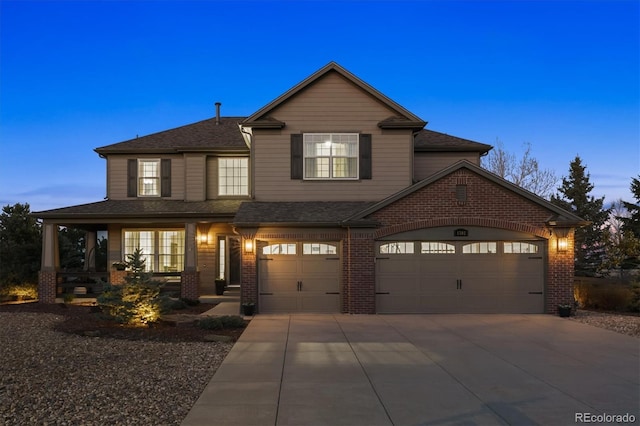 view of front facade featuring covered porch, concrete driveway, a shingled roof, and brick siding