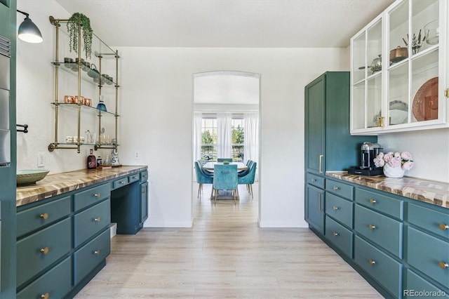 bar with baseboards and light wood finished floors