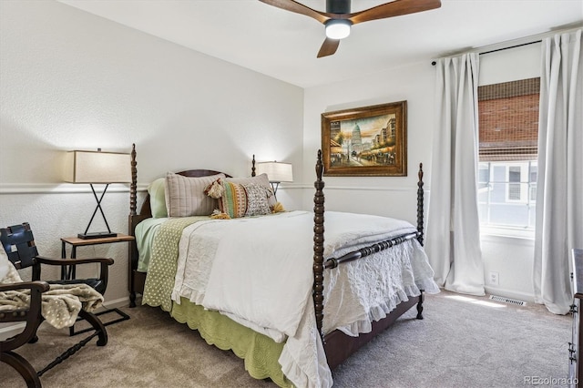 bedroom featuring visible vents, baseboards, a ceiling fan, and carpet floors