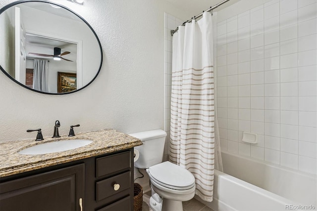 bathroom with toilet, shower / tub combo, ceiling fan, a textured wall, and vanity