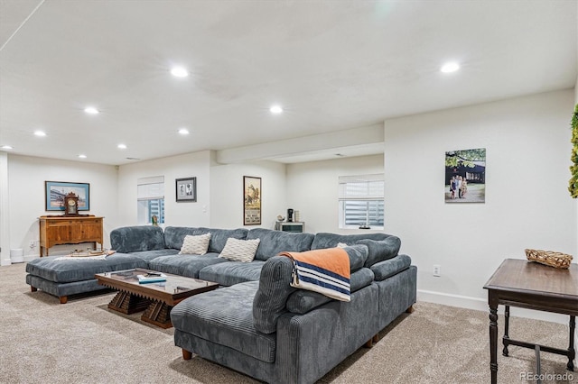 living area featuring light colored carpet, baseboards, and recessed lighting