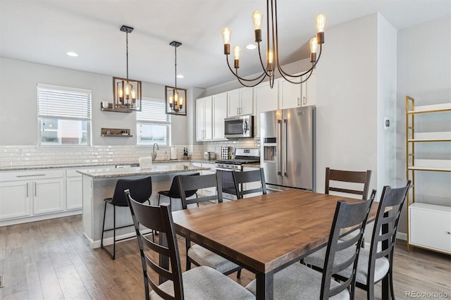 dining room featuring sink and light hardwood / wood-style flooring