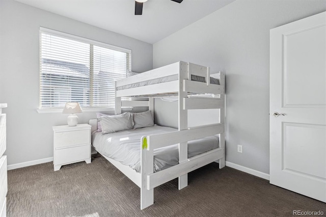 unfurnished bedroom featuring ceiling fan and dark colored carpet