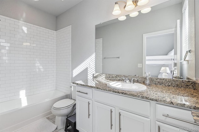 full bathroom with vanity, tiled shower / bath combo, and toilet