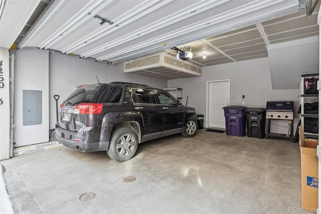 garage with a garage door opener and electric panel