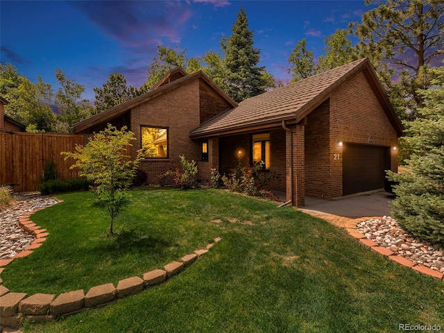 view of front facade featuring a garage and a lawn