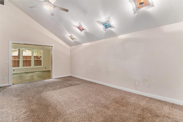 carpeted empty room featuring ceiling fan and vaulted ceiling