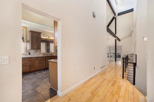 hall with dark hardwood / wood-style floors and sink