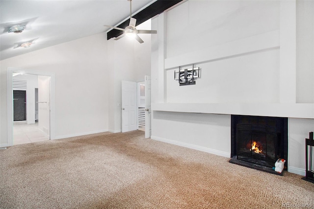 unfurnished living room with ceiling fan, light colored carpet, beam ceiling, and high vaulted ceiling